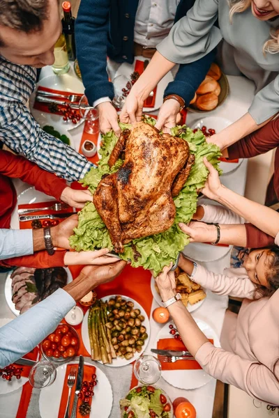 Family holding christmas turkey — Stock Photo