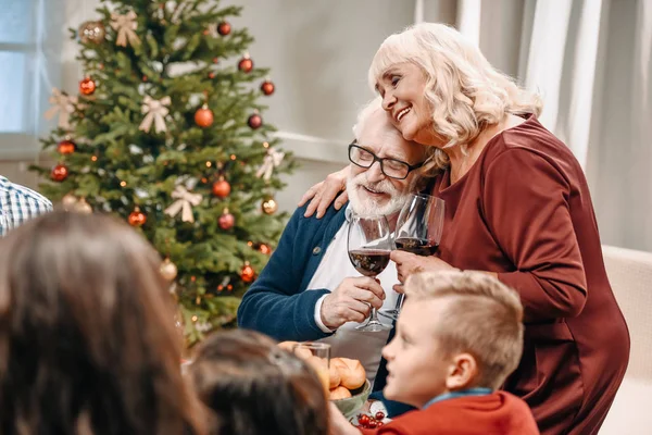 Senior couple clinking glasses on christmas — Stock Photo