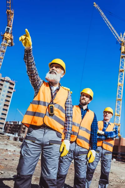 Polier verwaltet Bauarbeiter — Stockfoto