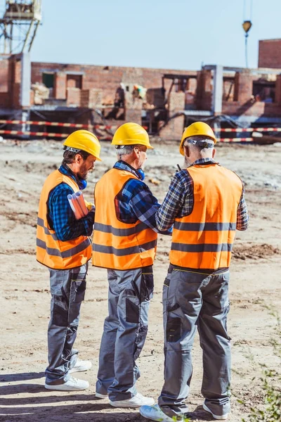 Three workers at construction site — Stock Photo