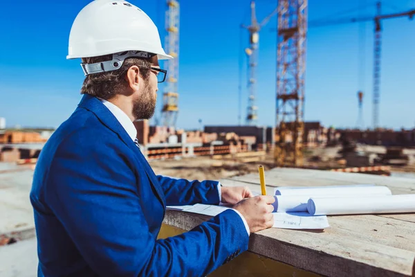 Businessman working at construction site — Stock Photo