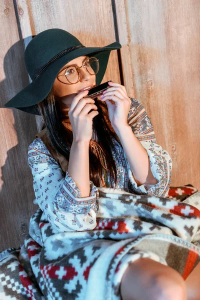 Hippie girl playing harmonica — Stock Photo