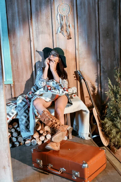 Hippie girl playing harmonica — Stock Photo