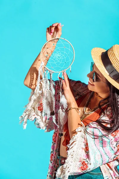 Hippie girl looking at dreamcatcher — Stock Photo