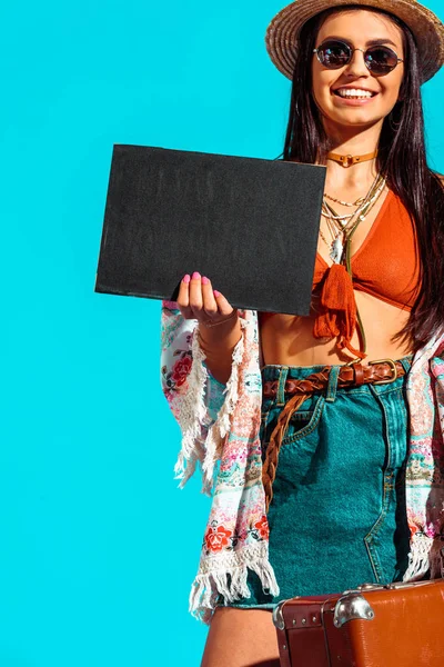 Bohemian traveler with black board and suitcase — Stock Photo