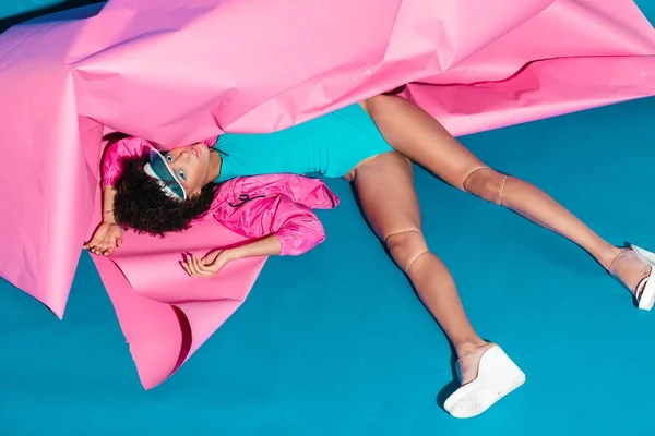 Model posing with pink paper — Stock Photo