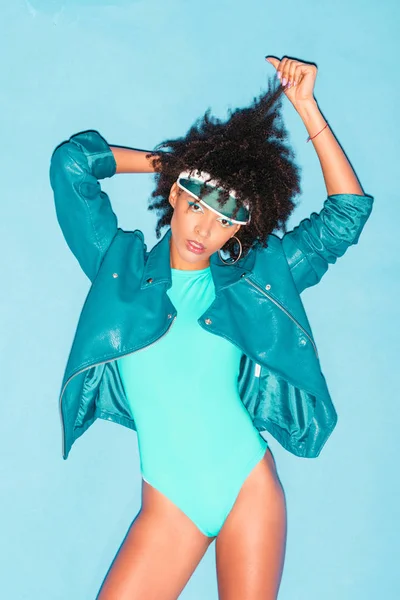 Model posing in turquoise bodysuit — Stock Photo
