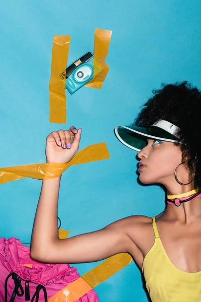 Stuck afro girl with camera — Stock Photo