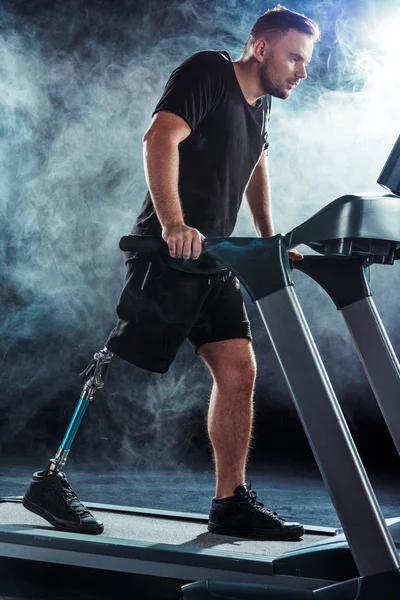 Paralympic sportsman exercising on treadmill — Stock Photo