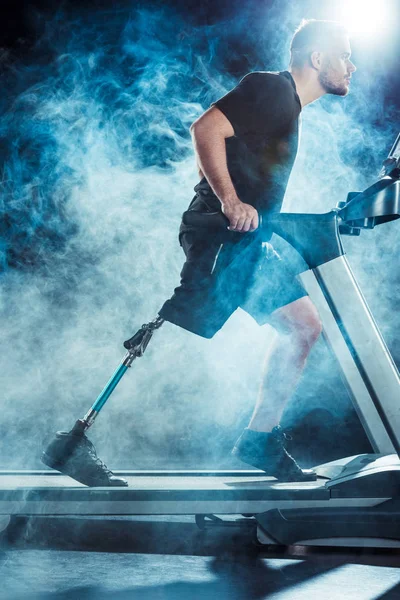 Paralympic sportsman exercising on treadmill — Stock Photo