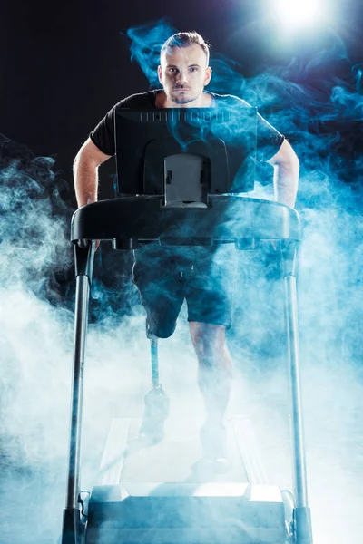 Paralympic sportsman exercising on treadmill — Stock Photo