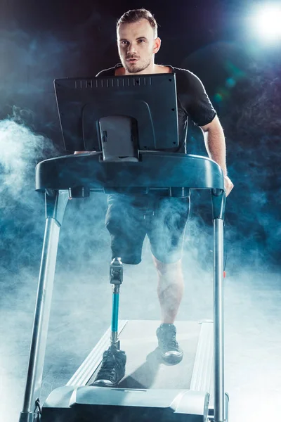 Paralympic sportsman exercising on treadmill — Stock Photo