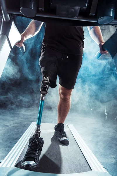 Sportsman with leg prosthesis training on treadmill — Stock Photo