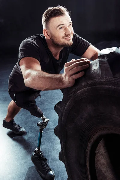 Paralympic sportsman pulling tire — Stock Photo