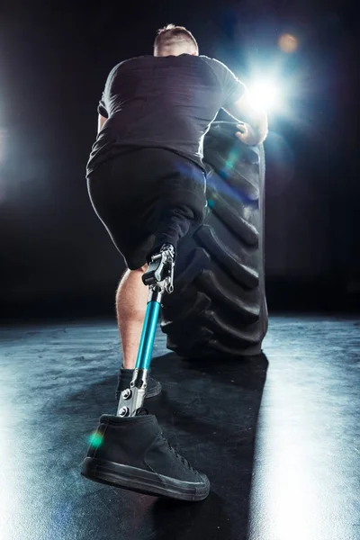 Paralympic sportsman pulling tire — Stock Photo