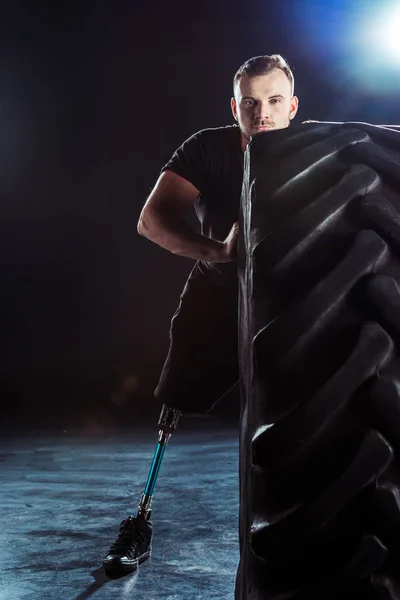 Paralympic sportsman pulling tire — Stock Photo