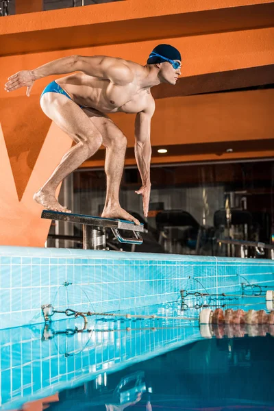 Swimmer on diving board ready to jump — Stock Photo