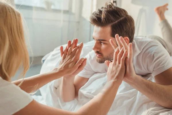 Couple holding hands in bedroom — Stock Photo