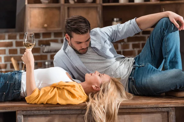 Couple laying on kitchen table — Stock Photo