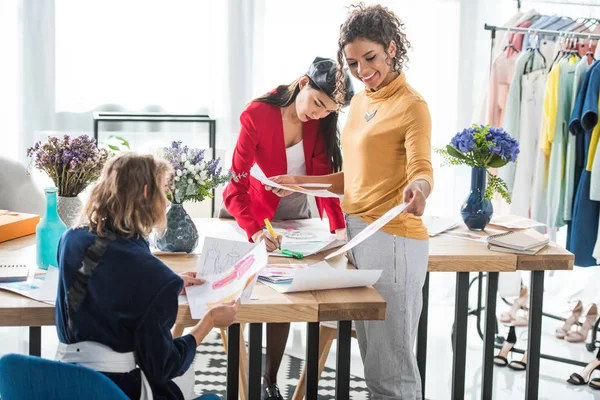 Fashion designers working with sketches — Stock Photo