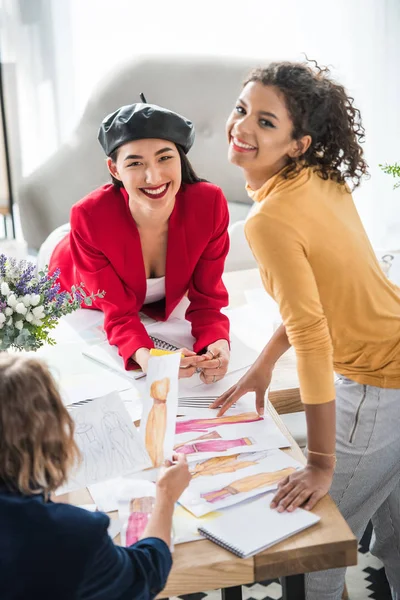 Fashion designers working with sketches — Stock Photo