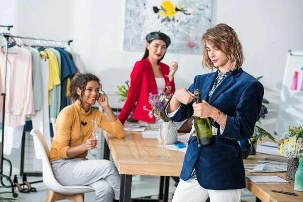 Fashion designers drinking champagne — Stock Photo