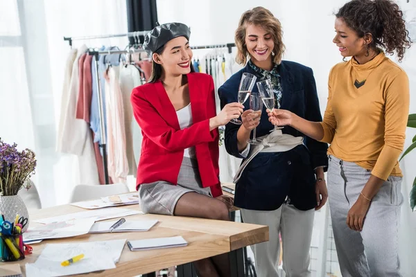 Fashion designers drinking champagne — Stock Photo