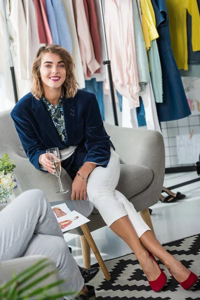 Fashion designers drinking champagne — Stock Photo