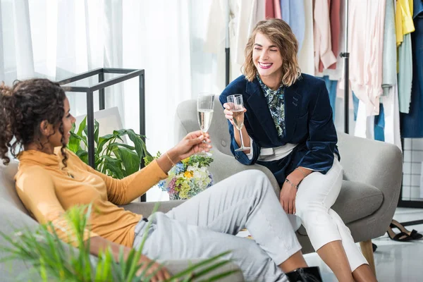 Fashion designers drinking champagne — Stock Photo