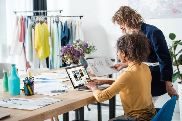 Fashion designers working with laptop — Stock Photo