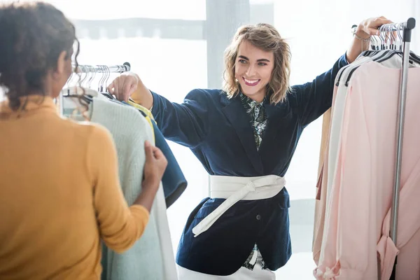 Fashion designers working with clothes — Stock Photo