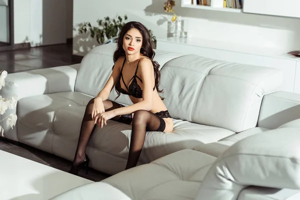 Seductive girl posing on sofa — Stock Photo