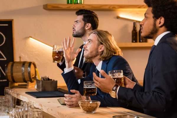 Empresários bebendo cerveja e assistindo jogo — Fotografia de Stock