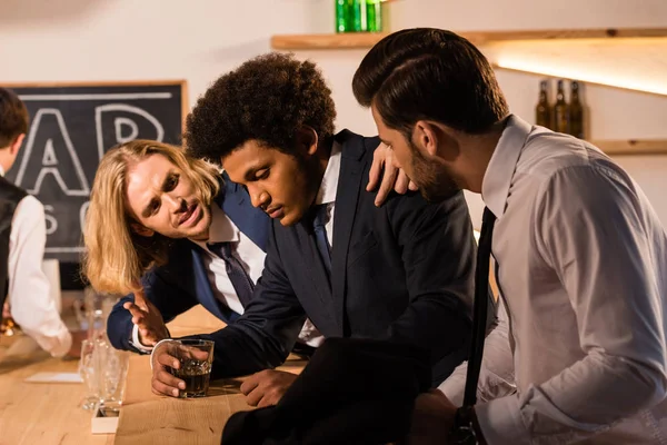 Businessmen drinking whiskey in bar — Stock Photo