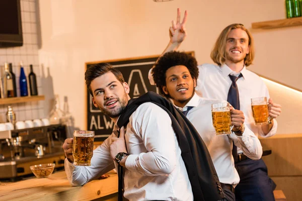 Businessmen drinking beer in bar — Stock Photo