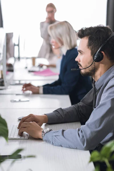 Call center operator in headset in office — Stock Photo