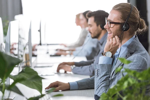 Opérateur de centre d'appels dans casque dans le bureau — Photo de stock