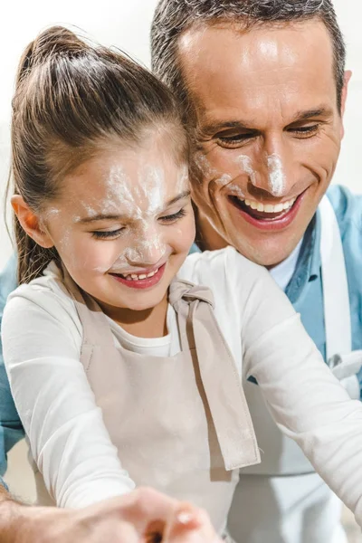 Father and daughter with faces in flour — Stock Photo