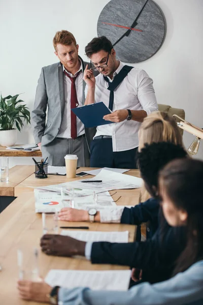 Group of businesspeople having conversation in conference hall at office — Stock Photo