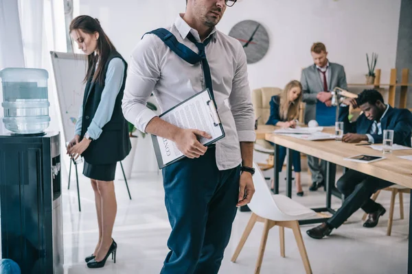 Cropped shot of exhausted untidy businessman going out conference hall at office — Stock Photo