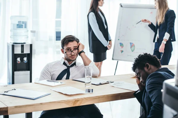 Group of exhausted managers having conversation at office — Stock Photo