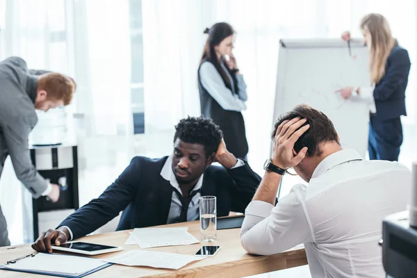 Group of tired businesspeople in conference hall at office — Stock Photo