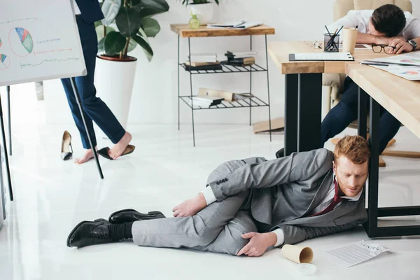 Group of exhausted businesspeople sleeping at office — Stock Photo