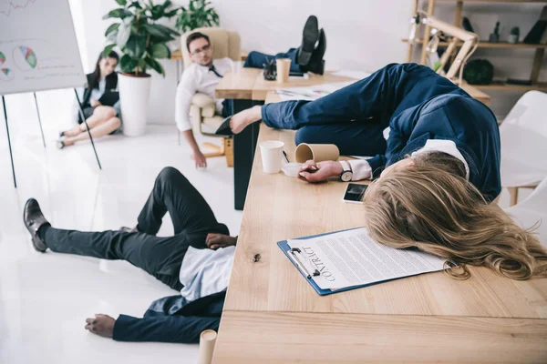 Tired business colleagues sleeping at office — Stock Photo