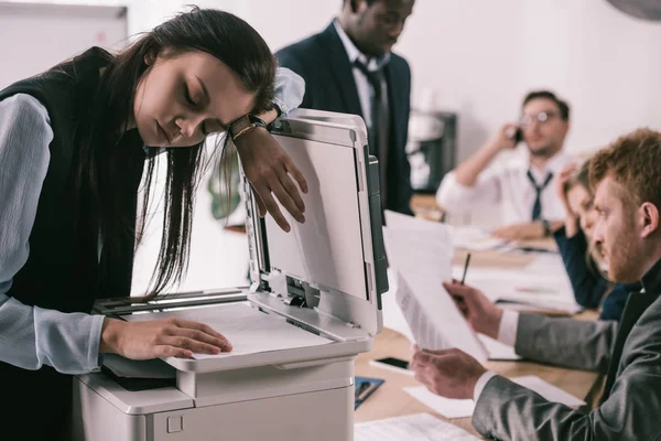 Exhausted zombie like businesswoman sleeping on copier at office — Stock Photo