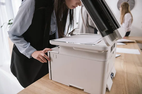 Exhausted young businesswoman sleepy leaning on copier at conference room — Stock Photo