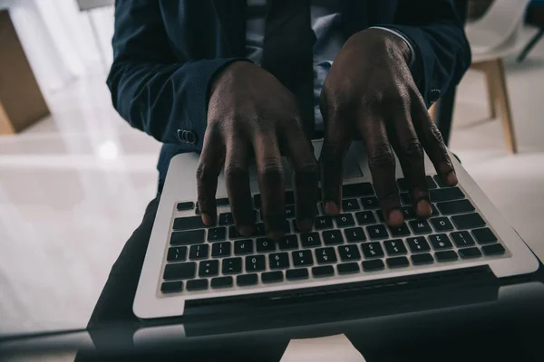 Recortado disparo de hombre de negocios afroamericano trabajando con el ordenador portátil - foto de stock