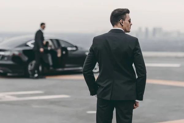 Rear view of bodyguard in suit and sunglasses — Stock Photo