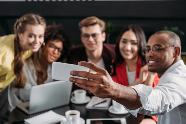 Close-up shot of group of young friends taking selfie at cafe — Stock Photo