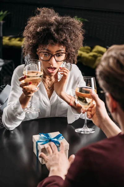 Chocado jovem mulher receber presente de aniversário do namorado — Fotografia de Stock